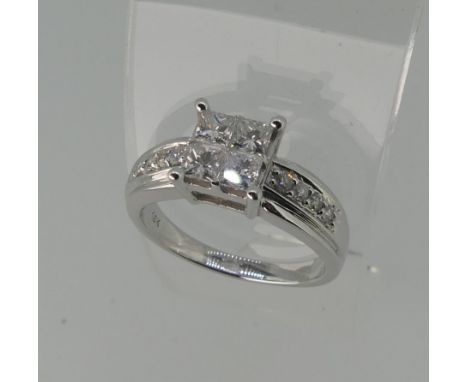 An 18ct white gold diamond Ring, the square front formed of four princess stones, each approx 0.2ct and with four graduated s