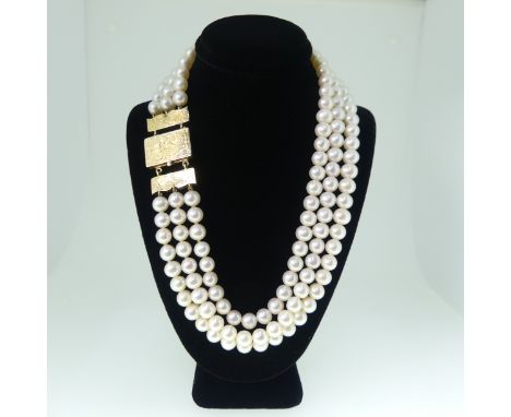 A triple row cultured pearl choker Necklace,&nbsp;the uniform pearls each approx. 6.5-7mm diameter, on unmarked gold clasp, t