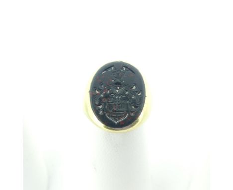 A 14ct gold and bloodstone Signet Ring, the oval matrix crested, the shank marked 585 and tested, Size H, total weight 6.3g. 