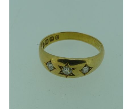 A graduated three stone diamond Ring, the centre stone approx. 0.06ct with a smaller stone on either side, all old cut and gy