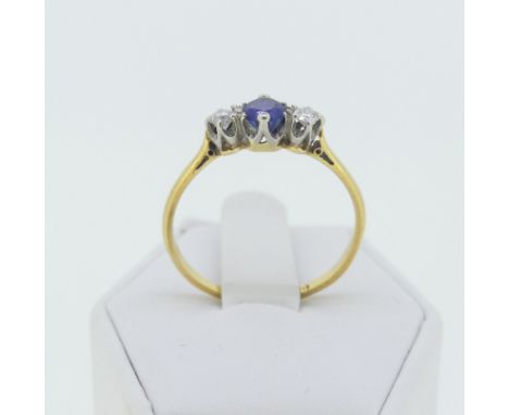 A sapphire and diamond three stone Ring, the central oval facetted sapphire approx 4x4.6mm, with a circular diamond on either