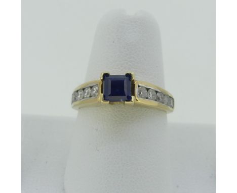 A sapphire and diamond Ring, the central square sapphire 4.65mm wide, with five brilliant cut diamonds channel set on either 