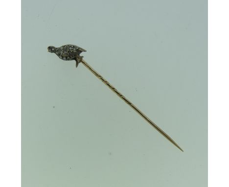 An antique Stick Pin, the finial modelled as a game bird set diamond points and ruby eye, all unmarked, 6.5cm long. 