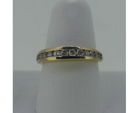 A diamond set half hoop Eternity Ring, the thirteen graduated small diamonds channel set in 9ct yellow gold, Size N, approx t