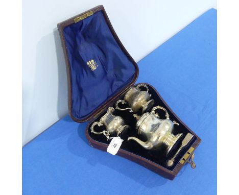 A cased Victorian silver three piece bachelor Tea Set, by Daniel &amp; Charles Houle, hallmarked London, 1861, of waisted cir