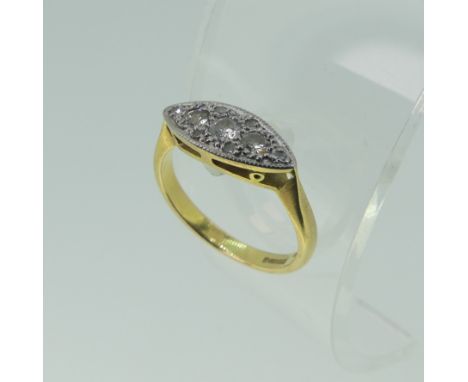 A small three stone diamond Ring, all mounted in a lozenge front with six further diamond points, 18ct yellow gold shank, Siz