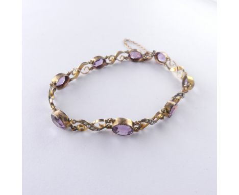 An early 20thC amethyst and seed pearl Bracelet, the eight oval facetted amethysts millegrain set with seed pearl set X shape