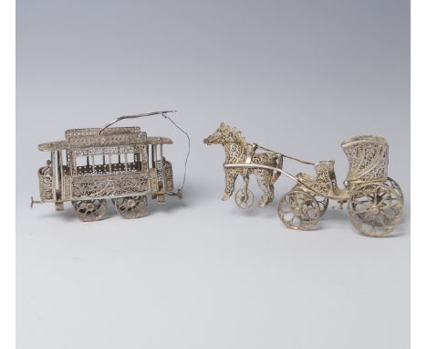 An early 20th century silver filigree miniature model of a Tram, with four wheels and pantograph, 9cm long, together with a s