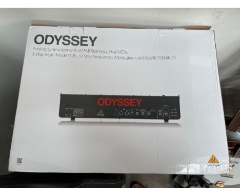 A Behringer Odyssey analog synthesizer with bag, manual and box