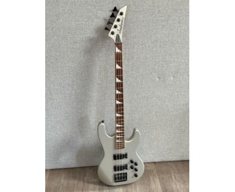 A Jackson electric bass guitar, silver body, serial number NHJ1119713