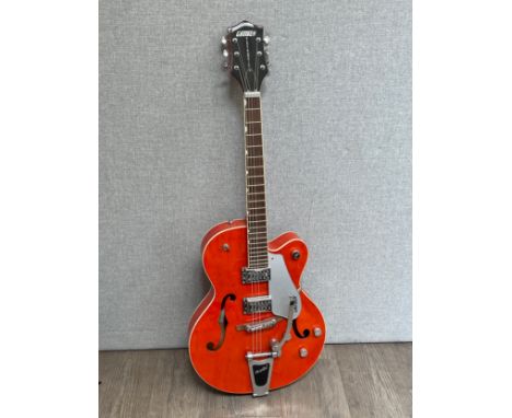 A Gretsch Electromatic electric guitar, semi acoustic, in orange, with hard case
