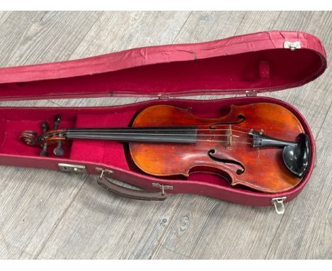 A late 19th / early 20th Century full size (4/4) violin, spruce top, figured maple two piece back, no maker label, cased