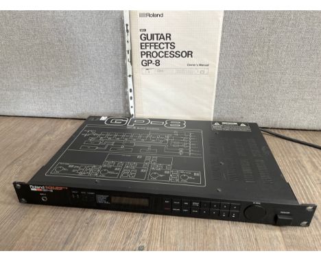 A Roland GP-8 guitar effects unit, with manual