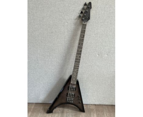 An unbranded electric bass guitar with mottled graphite coloured body, Flying V influenced form
