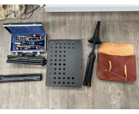 A cased composite clarinet together with music stands, brass instrument rest and music case