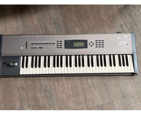 A Korg N364 music workstation keyboard with manuals 