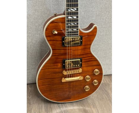 A Gibson Les Paul Supreme electric guitar, trans amber figured finish, circa 2003, serial number 02303582, with Gibson fitted