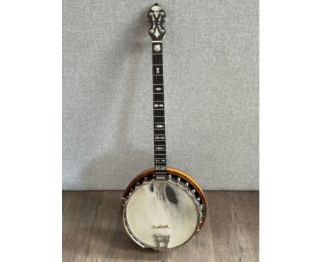 A Cammeyer 'New Era 1925' four string banjo, mother of pearl engraved inlay, figured and inlaid maple back, soft case