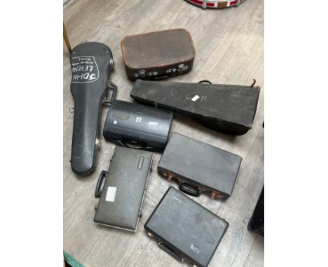 A collection of instrument cases including mandolin, violin and cornet