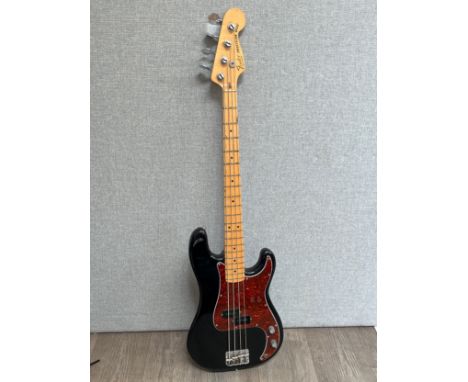 A Fender USA Precision bass circa 1978-81, CBS era, black body with tortoiseshell effect pickguard, maple neck, serial number