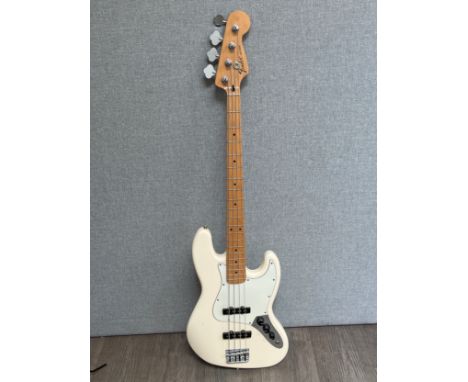 A Fender Jazz bass, Mexican, Olympic white body, serial number MX17982701, Fender soft case
