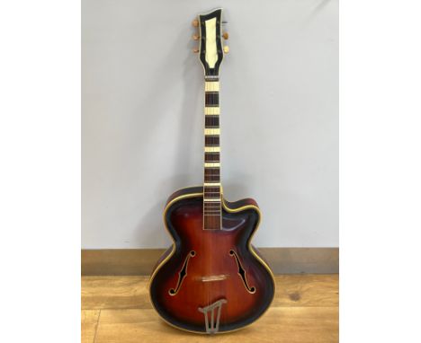 A 1950's hollow body acoustic guitar converted into a tenor (4 string), sunburst body, bridge marked Maruna