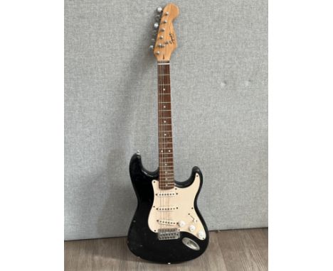 A Fender Squire Stratocaster electric guitar with black body 