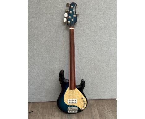 An Ernie Ball Stingray 5 bass guitar with hard case 