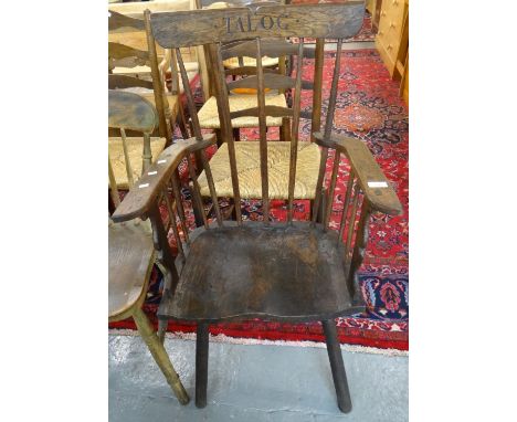 Primitive design oak stick back elbow chair carved 'Talog'.  (B.P. 21% + VAT) 