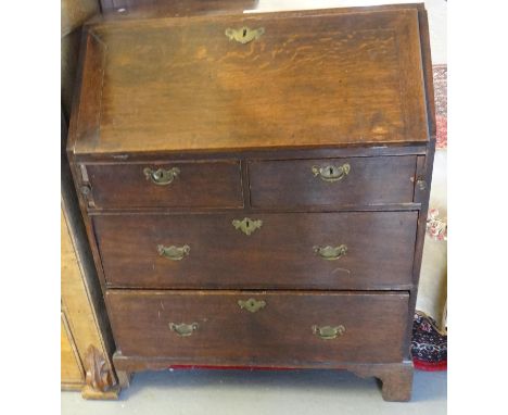 18th Century oak fall front bureau, revealing four small drawers and four pigeon holes flanking a central cupboard, above two
