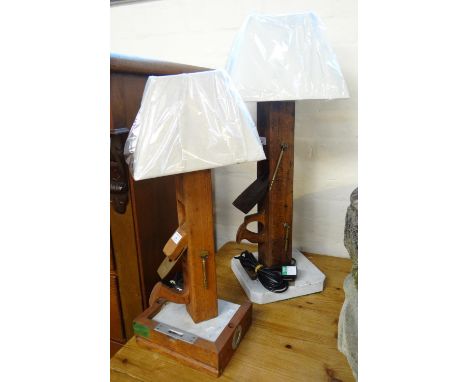 Two similar novelty wooden table lamps formed from vintage block planes, with marble bases and linen shades.  65 and 79cm hig