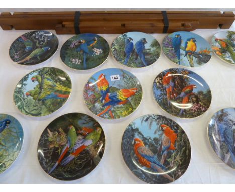 Set of 12 Wedgwood 'Fragile Paradise' parrot collectors plates together with display shelf