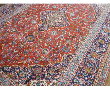 Red ground Persian Kashan traditional floral design carpet( approx 13' 2" x 9' 6")