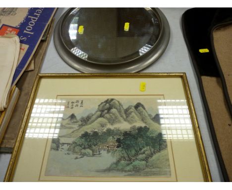 Heavy gauge vintage circular pewter style wall mirror and a framed Japanese watercolour of mountains with houses to the foreg