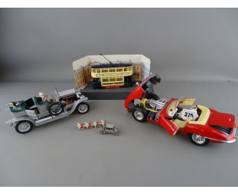 Burago model of a 1961 Jaguar E, a 1986 Franklin Mint Rolls Royce Silver Ghost, a Corgi diecast tram on display stand and a m