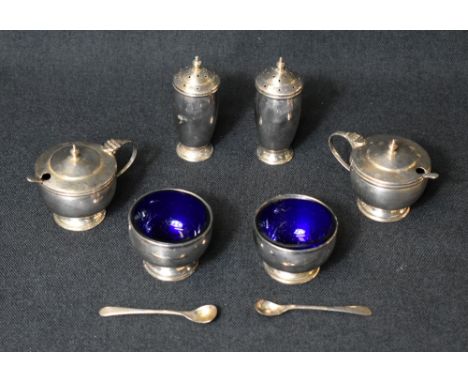 A cased George V silver condiment set, comprising two salts, two mustards and two pepperettes, all of circular form raised on
