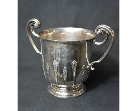A large late Edwardian silver wine cooler, of traditional form having a slightly flared rim, ornate scroll handles and decora