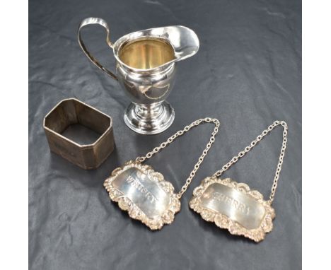 A Victorian silver cream jug, of traditional form having a generous spout opposed by a curved handle, raised on a circular st