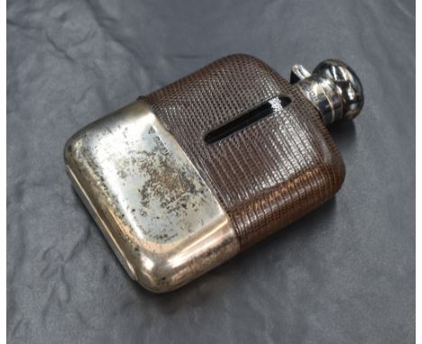 A George VI silver mounted glass hip flask, of traditional form having a silver mount and cap to the top and a leather cover 