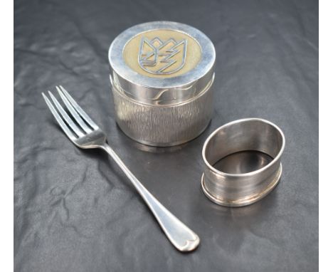 An Elizabeth II Longdale Estate silver trinket box, of circular form having a monogram design to the top, with textured desig
