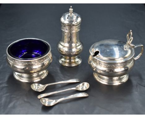 A George V silver three piece condiment set, comprising salt, mustard and pepper, of bulbous form having a band of decorative