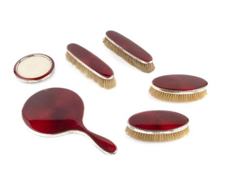 A silver and red enamel backed dressing table set, comprising hand mirror and two pairs of clothes brushes, by Horton &amp; A