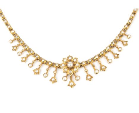 A late 19th/early 20th century half pearl fringe necklace, suspending a graduated fringe of foliate panels and centred with a
