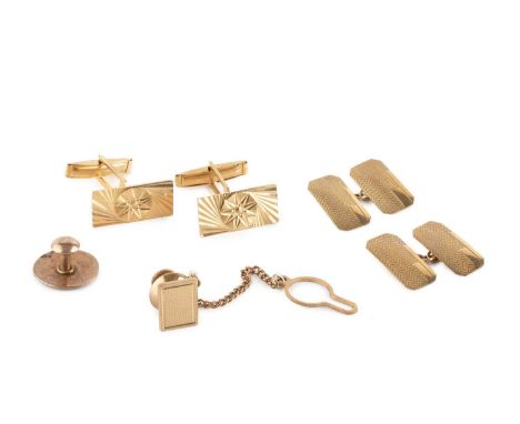 A pair of cufflinks, each rectangular panel with star engraved decoration, on hinged baton fittings, stamped '750', together 