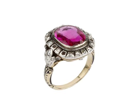 A synthetic ruby, diamond and enamel cluster ring, the possibly later replaced cushion-shaped synthetic ruby in collet settin