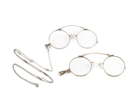 Two pairs of lorgnettes, decorated with foliate borders, each white metal mounted and stamped '14K', together with a white me