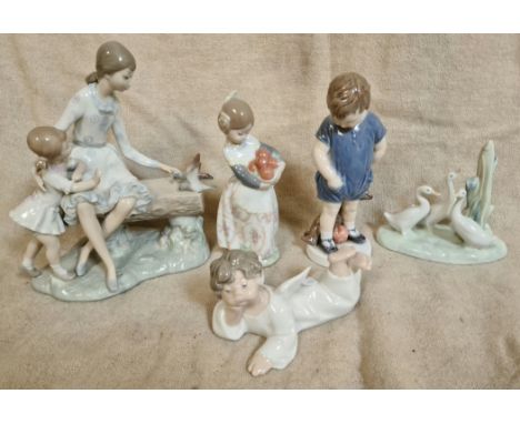 Five porcelain figures comprising two Nao, one Lladro and one Royal Copenhagen.Condition:- bears head has been glued back on,