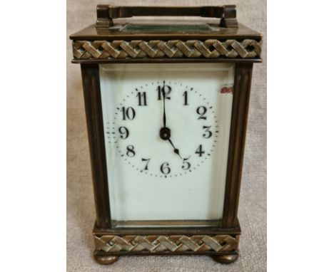A brass carriage clock with key.  