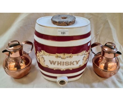 A ceramic whiskey barrel and a pair of Guernsey copper milk cans.