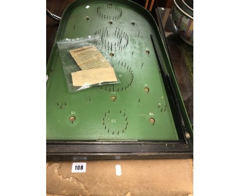 A vintage 1920's bagatelle board, inc. instructions